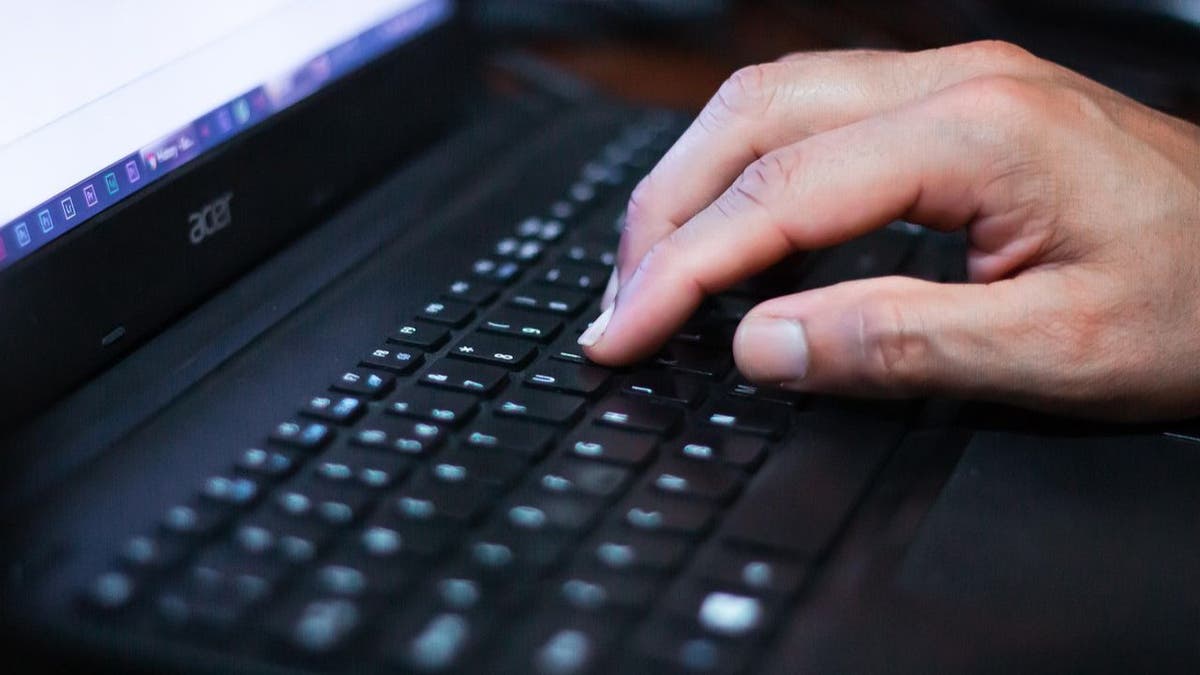 person writing on the keyboard